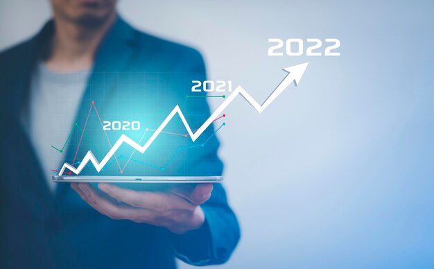 Businessman holding tablet bar graph of analytics and financial Changes in new planning Business