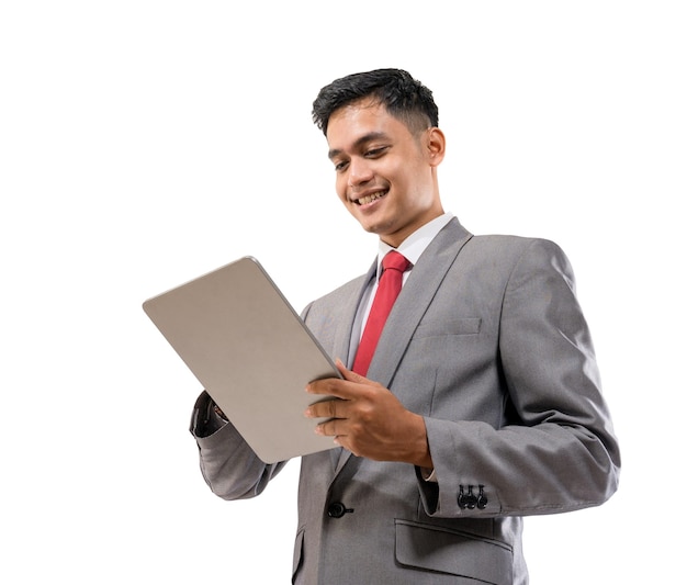 Businessman holding tablet pc isolated over white background