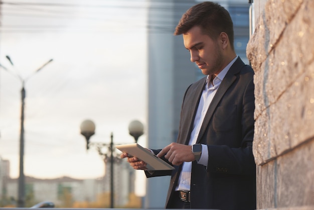 Businessman holding a tablet and pointing finger of the other hand on tablet