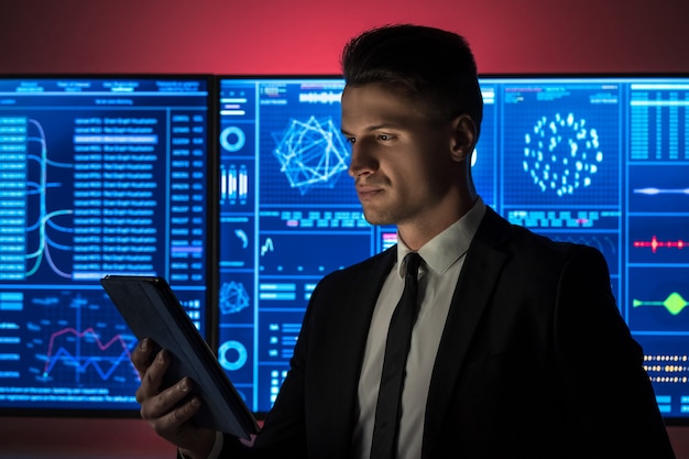 The businessman holding a tablet in the red lab