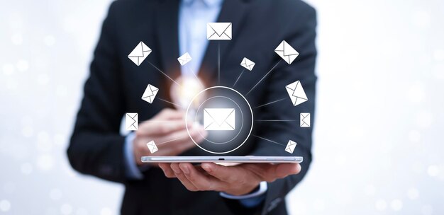 Businessman holding a tablet with communication icons, letter icon, email icons, and newsletter email and protect your personal information or spam mail, Customer service call center contact.