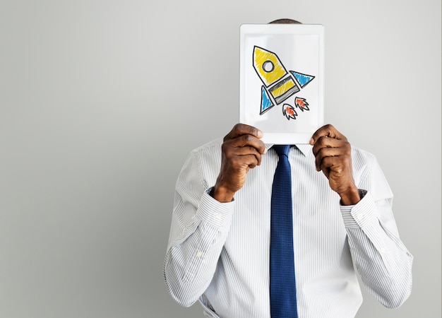 Businessman holding tablet with rocket spaceship icon