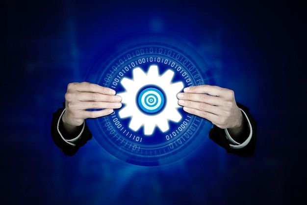 Businessman holding target with cog wheel gear icon