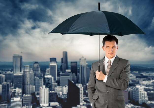 Photo businessman - holding an unbrella