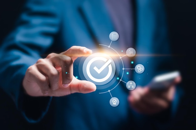Businessman holding virtual approve icon for service guarantee business process automation quality assurance management certification digital transformation