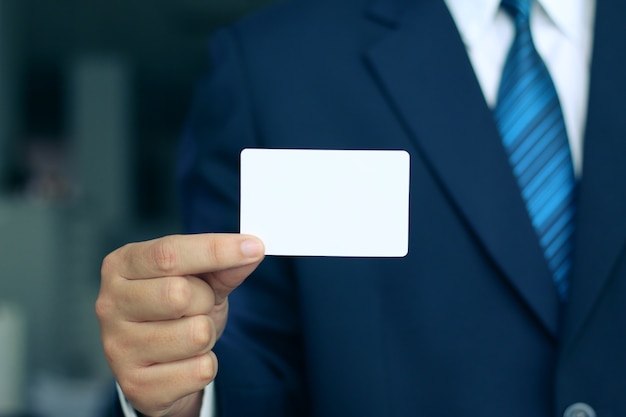 Businessman holding a white business card
