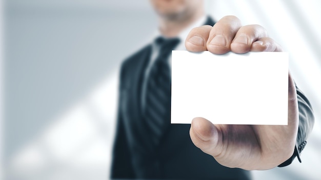 Businessman holding a white business card