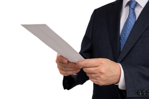 Businessman holding a white envelope in his hand.