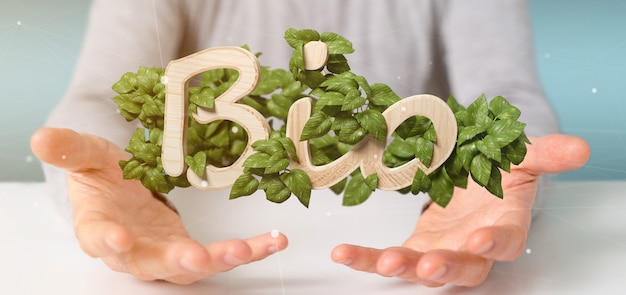 Photo businessman holding wooden logo bio with leaves around