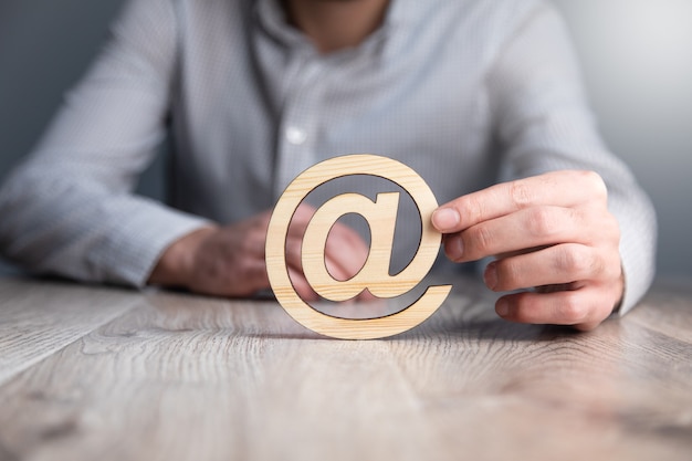 Businessman holding wooden at symbol