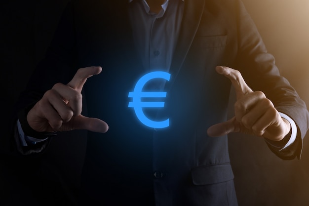 Businessman holds Euro symbol