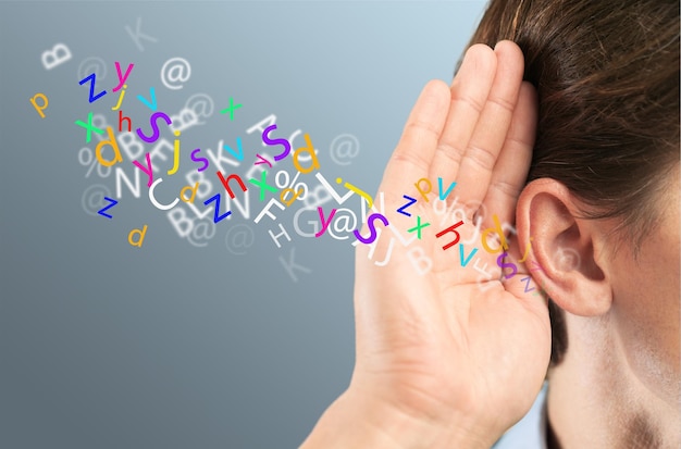 Businessman holds his hand near his ear and listening something