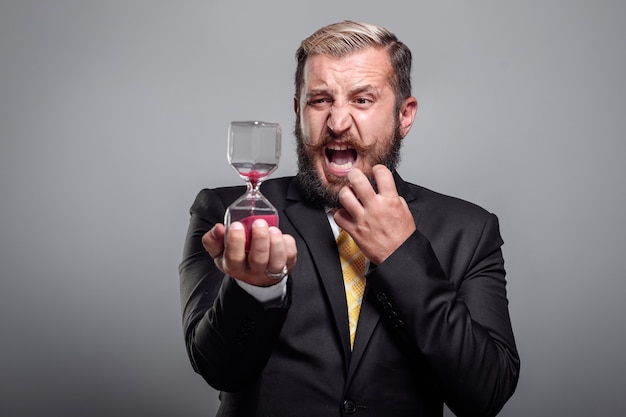 Businessman holds hourglass