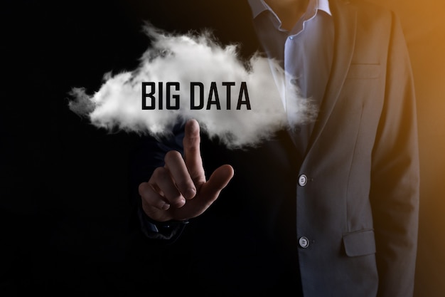 Photo businessman holds the inscription big data. padlock , brain ,man, planet,graph, magnifier, gears, cloud, grid, document, letter, phone icon.