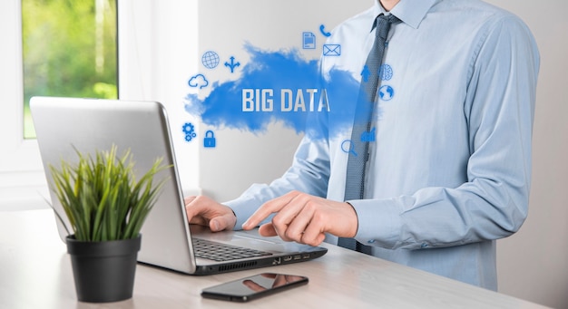 Businessman holds the inscription , word big data. padlock ,
brain ,man, planet,graph, magnifier, gears, cloud, grid, document,
letter, phone icon.