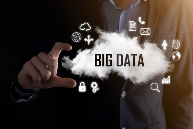 Businessman holds the inscription word BIG DATA. Padlock , brain ,man, planet,graph, magnifier, gears, cloud, grid, document, letter, phone icon.