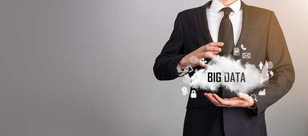 Businessman holds the inscription , word big data. padlock ,
brain ,man, planet,graph, magnifier, gears, cloud, grid, document,
letter, phone icon.