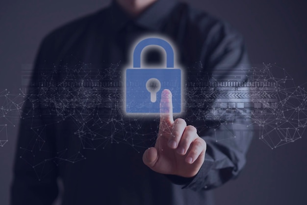 A businessman holds a lock icon hologram as the symbol of online data and information security