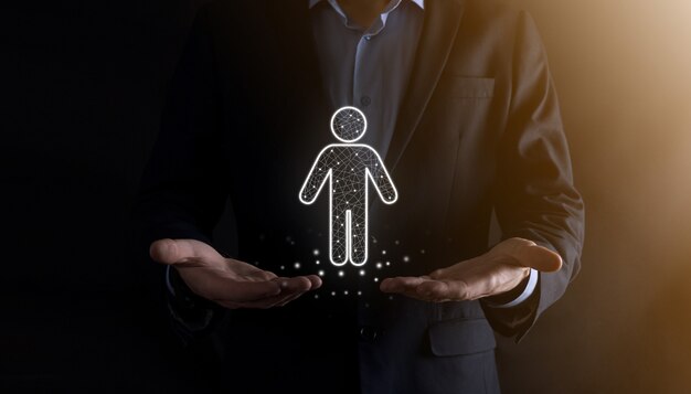 Businessman holds man person icon on dark tone wall.HR Human ,people iconTechnology Process System Business with Recruitment, Hiring, Team Building.