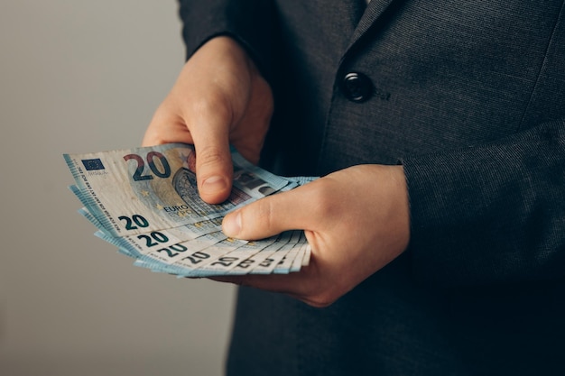 Businessman holds money in his hand man counts money