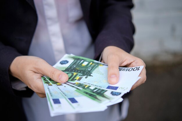 Businessman holds paper money, currency from the euro