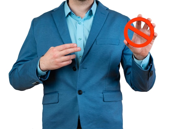 Businessman holds a red NO prohibition symbol