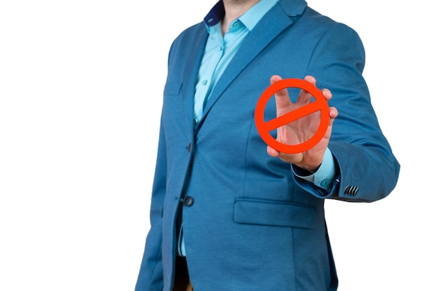 Businessman holds a red NO prohibition symbol