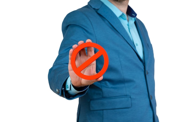 Businessman holds a red NO prohibition symbol