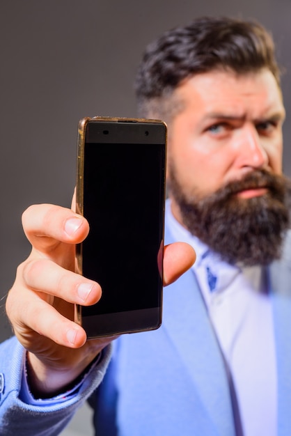 Businessman holds smartphone business communication internet technology concept businessman show