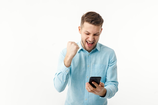 A businessman holds a smartphone and rejoices at a successful transaction Remote work freelance