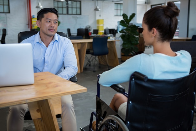 Businessman interacting with disabled colleague