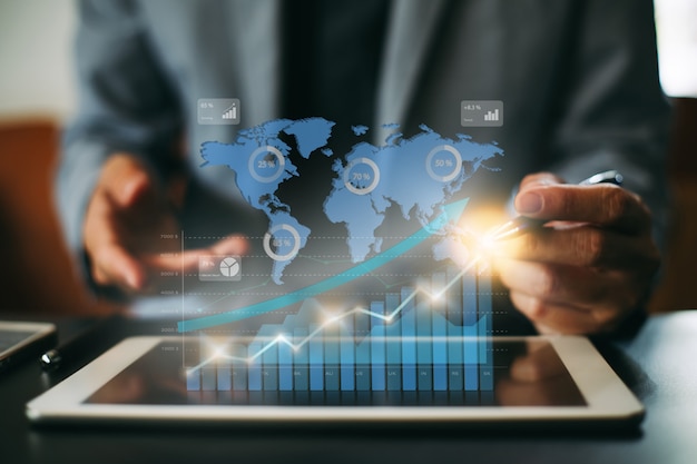 businessman investment analyzing company financial report with digital graphs.