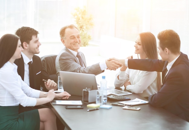 Businessman and investor shake hands at the negotiating table