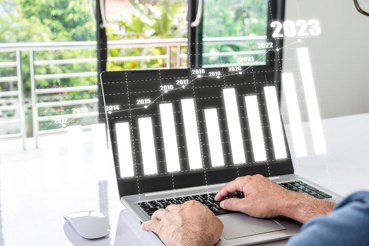Businessman is positively analyzing business growth indicators Concept for Real Estate Finance Banking Petroleum 2023 and Gold Graph shows economic growth in every business Blurred background