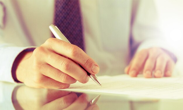 Businessman is signing a contract, business and law details