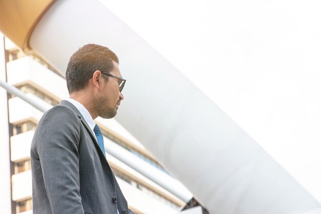 Businessman is standing at building