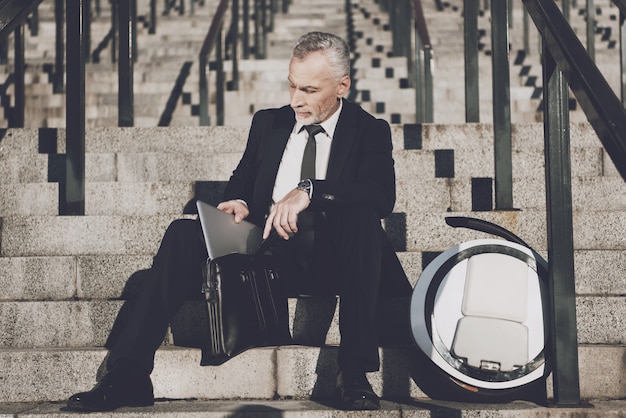 Businessman is Take Laptop from Briefcase