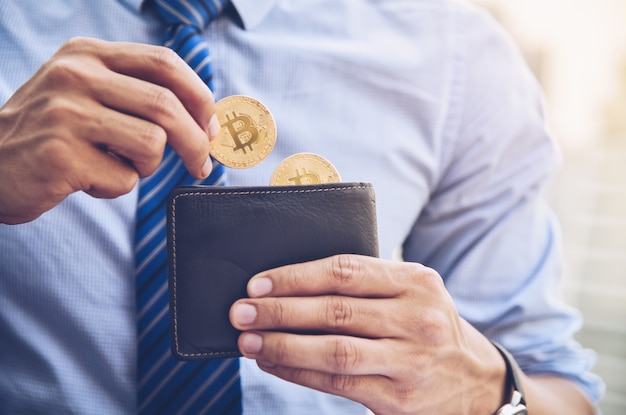 A businessman is taking a coin bit in a wallet