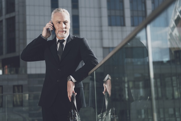 Businessman is Talking on Mobile Phone