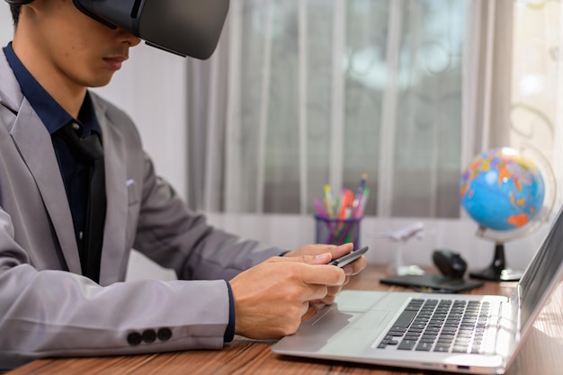 Businessman is using VR glasses to work. Virtual world.