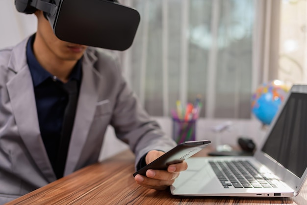 Businessman is using VR glasses to work. Virtual world.