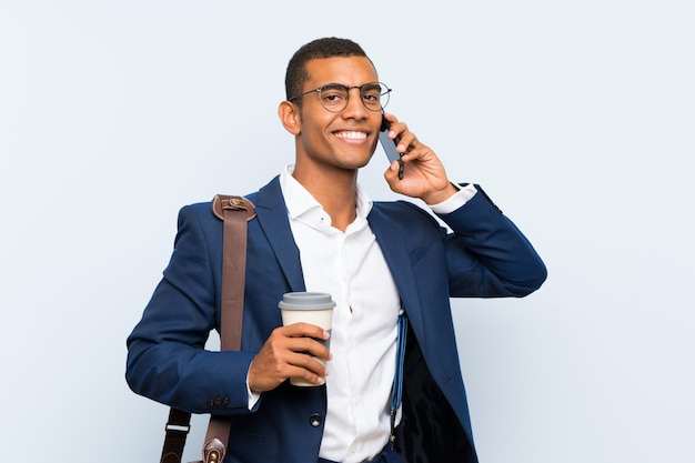 Businessman over isolated blue wall