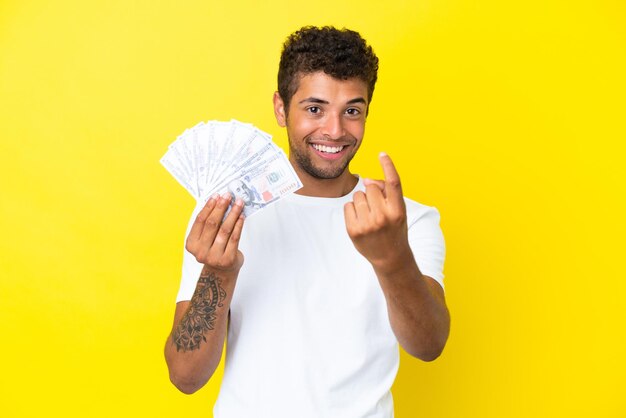 Businessman on isolated yellow background laughing