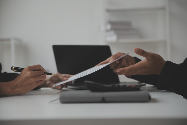 Businessman or job seeker review his resume on his desk before send to finding a new job with pen necktie glasses and digital tablet