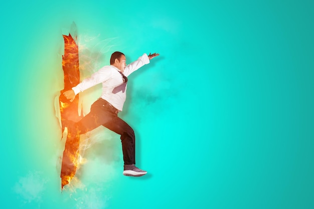 Photo businessman jumping obstacles through torn paper