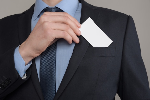 Businessman keeping a blank business card on his pocket