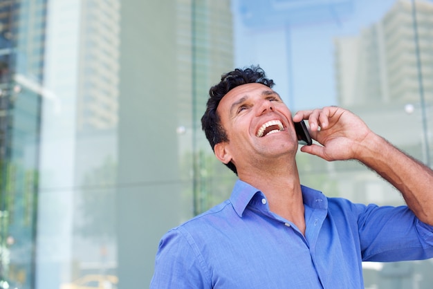 Businessman laughing with cell phone