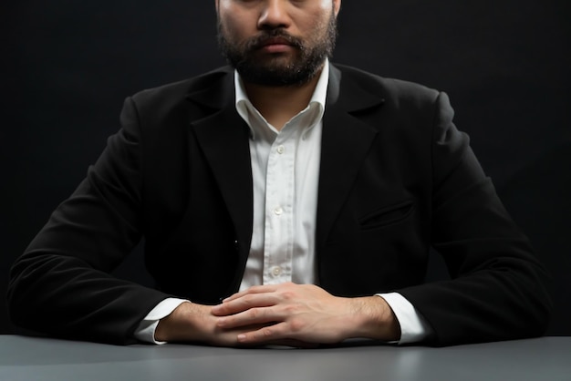 Businessman or lawyer wearing formal black suit sitting at table equility