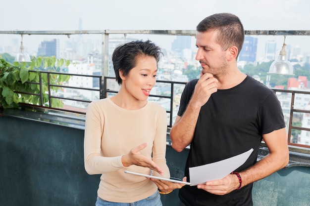 Businessman listening to coworker