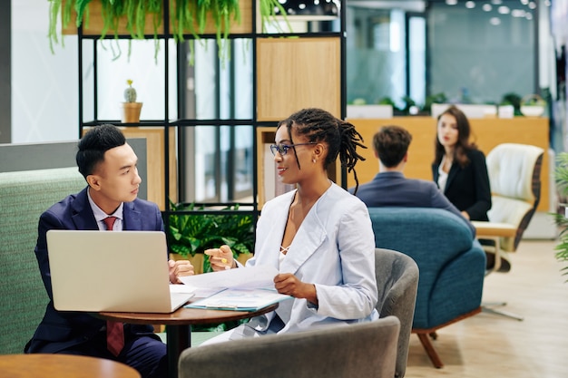 Businessman listening to female coworker